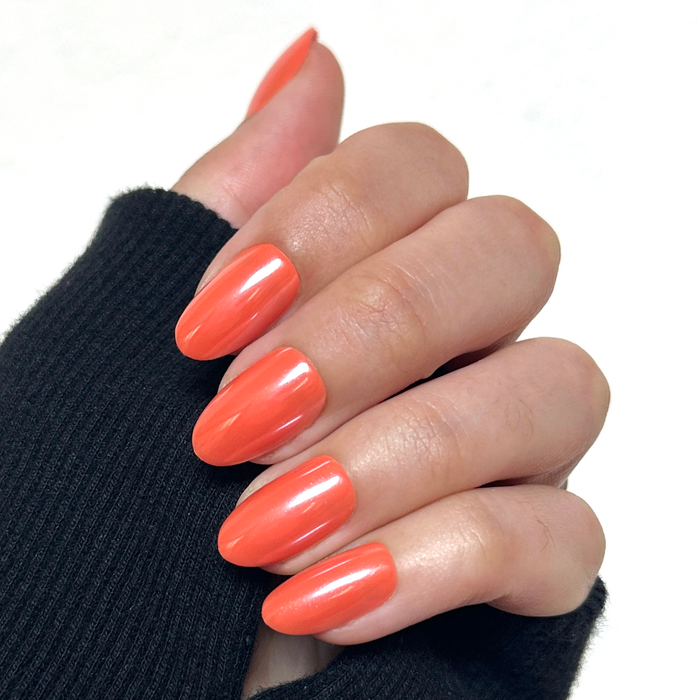 Bounce Back Chrome - Press-On | Medium | Oval medium oval bright tangerine orange press-on nails with chrome shimmer on hand