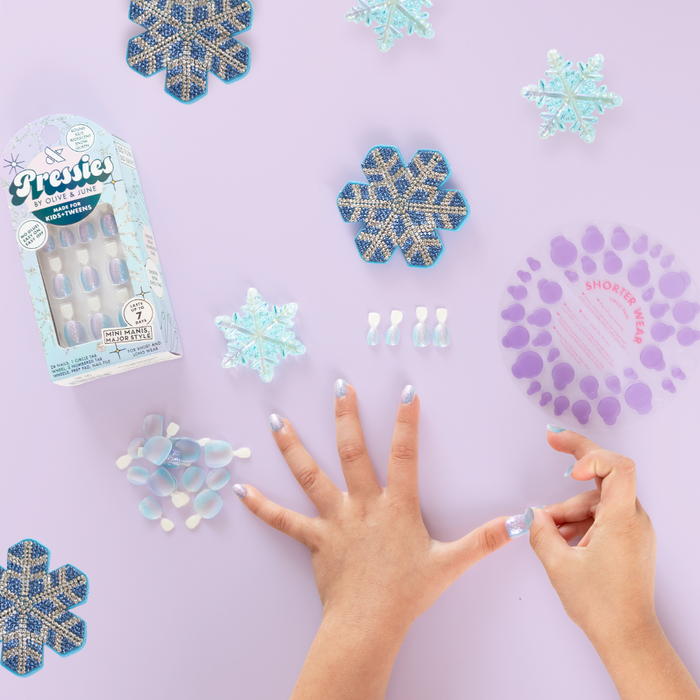 Iridescent Snow Queen - Pressies | Extra Short Short | Round showing iridescent multi-colored press-on nails on hands with snowflake decor