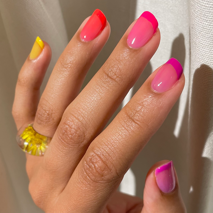 Lemon Drop yellow with rainbow jelly French tip nail art and a yellow ring