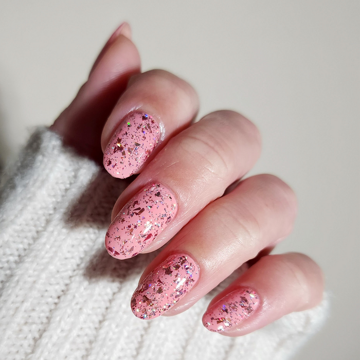 Set the Barre High rosy pink nail polish with pink glitter tip accent nails on a light skin tone