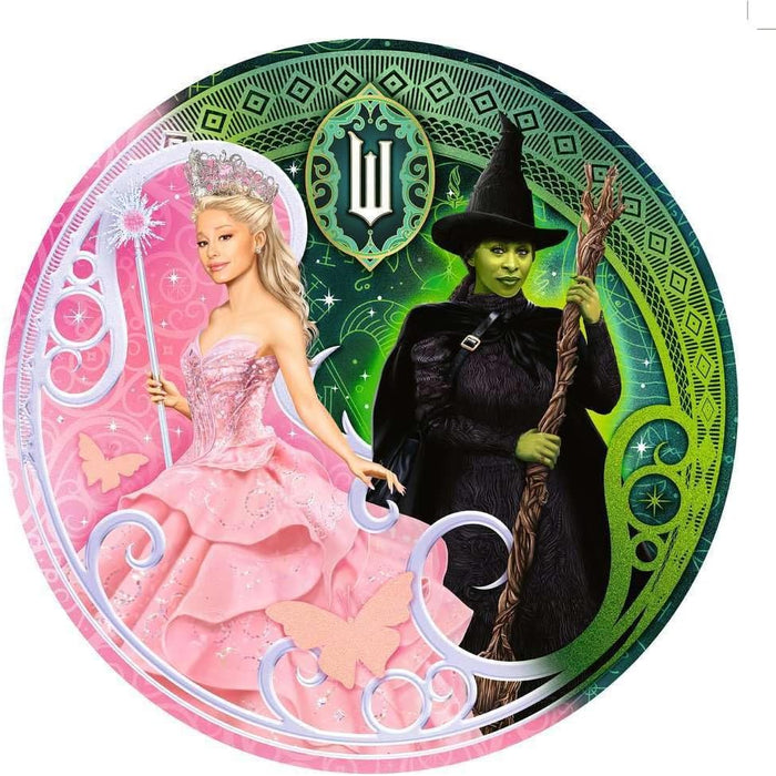 Circular ravensburger wicked story of two halves jigsaw puzzle featuring Glinda in a pink dress and Elphaba in black with a broomstick, surrounded by decorative elements.