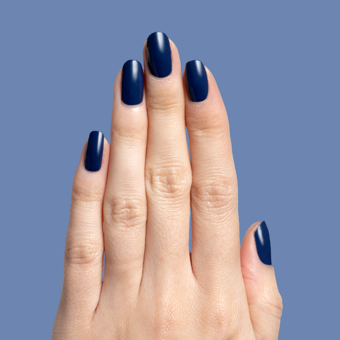 Hand with smooth, navy gel polish nails showcasing Ack, A Shark! for a durable, deep ocean-inspired manicure look