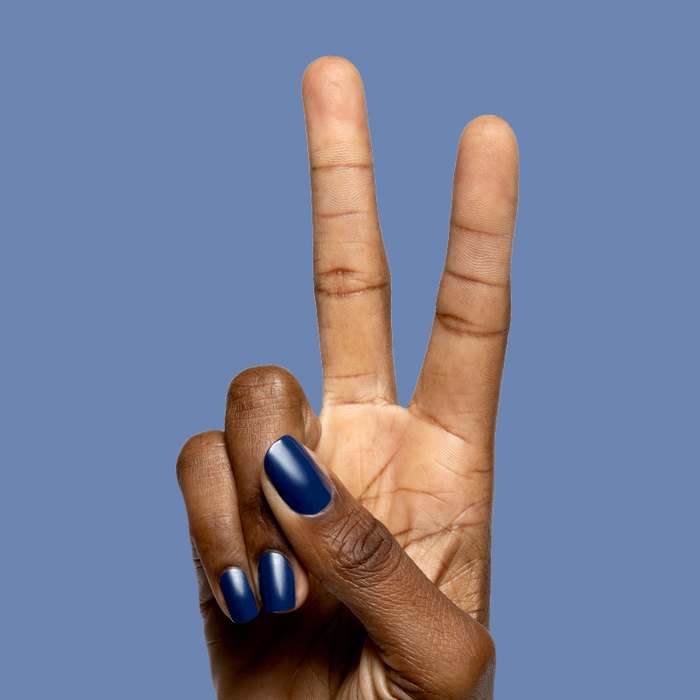 Hand with navy blue gel polish nails in a peace sign gesture featuring Ack, A Shark! for a sleek mani look