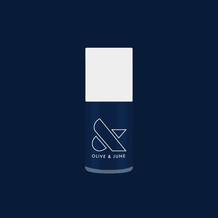 Olive and June bottle of Ack, A Shark! nail polish in deep navy blue for a long-lasting gel mani finish