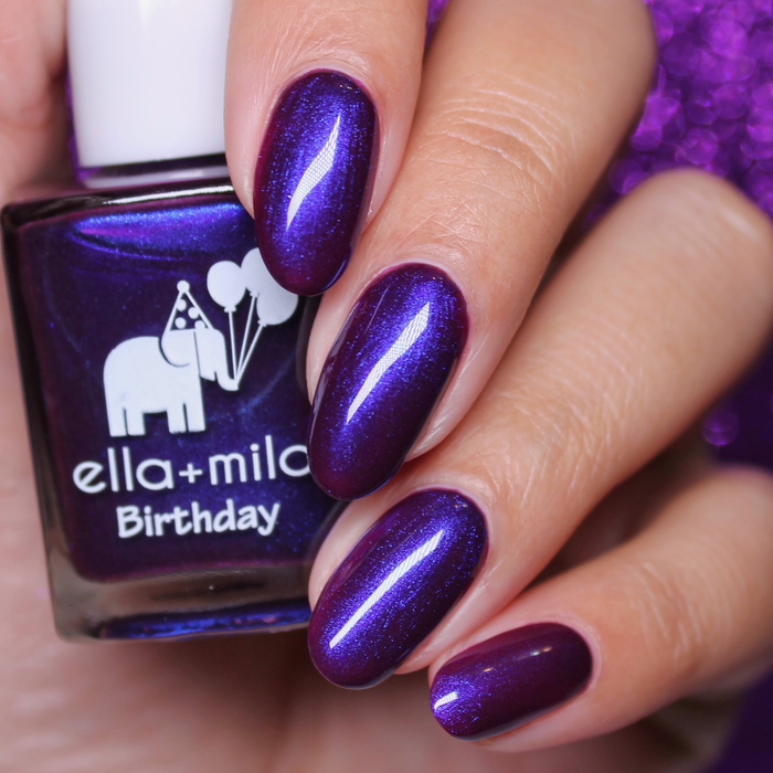 Amethyst Kiss iridescent purple nail polish close-up with the bottle