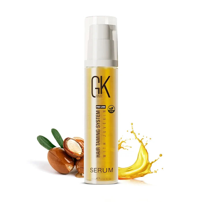 GK Hair Argan Oil Serum, 10 ml gold pump bottle labeled Serum with a white cap, argan nuts and an oil splash beside it