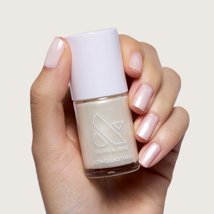 Atlas pearly white polish on natural nails with a subtle shimmer for a long-lasting at-home manicure by Olive and June