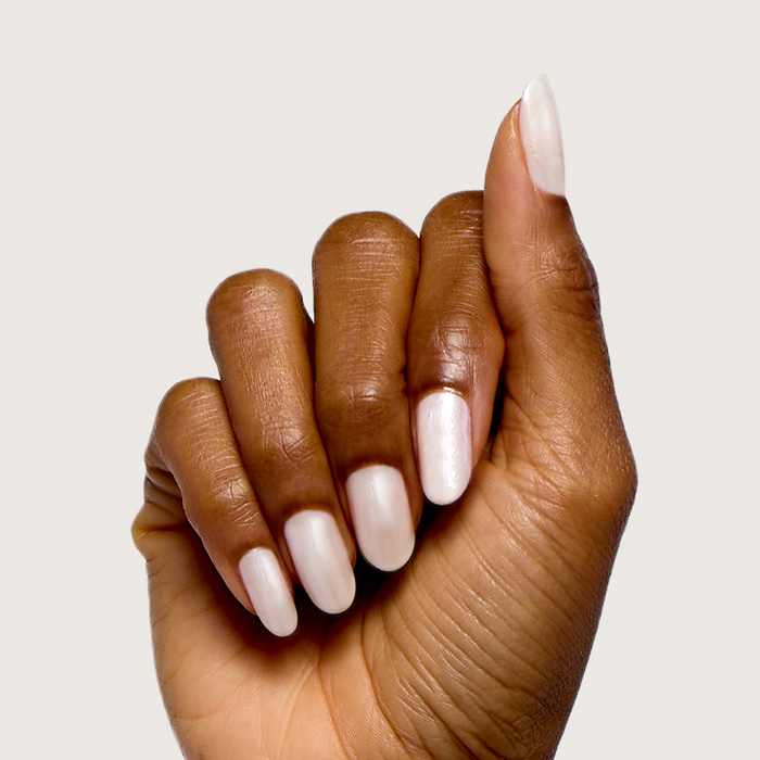 Atlas pearly white polish on natural nails with a soft shimmer for a long-lasting, quick dry at-home manicure by Olive and June