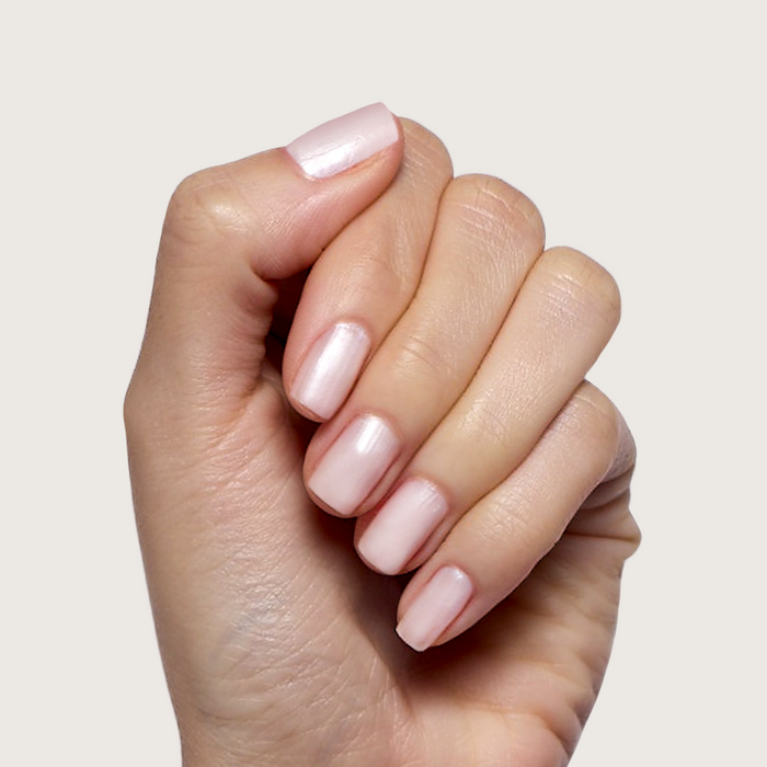 Atlas pearly white polish on natural nails with a soft sheen for a quick dry, long-lasting at-home manicure by Olive and June