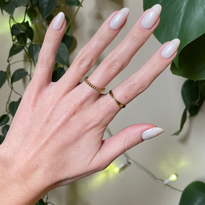 Atlas pearly white gel polish on almond-shaped nails with a smooth, luminous finish for an easy at-home manicure by Olive and June