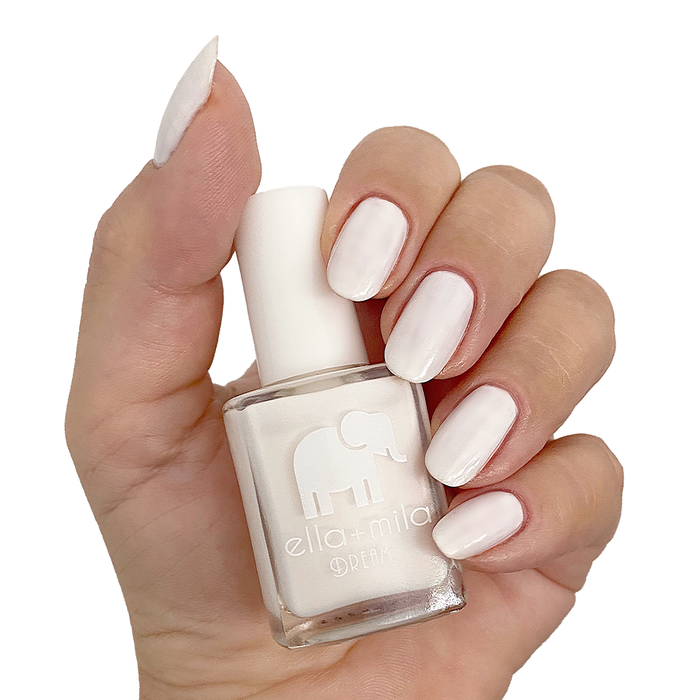 Ballet It On Me milky ivory nail polish manicure on a light skin tone with the bottle
