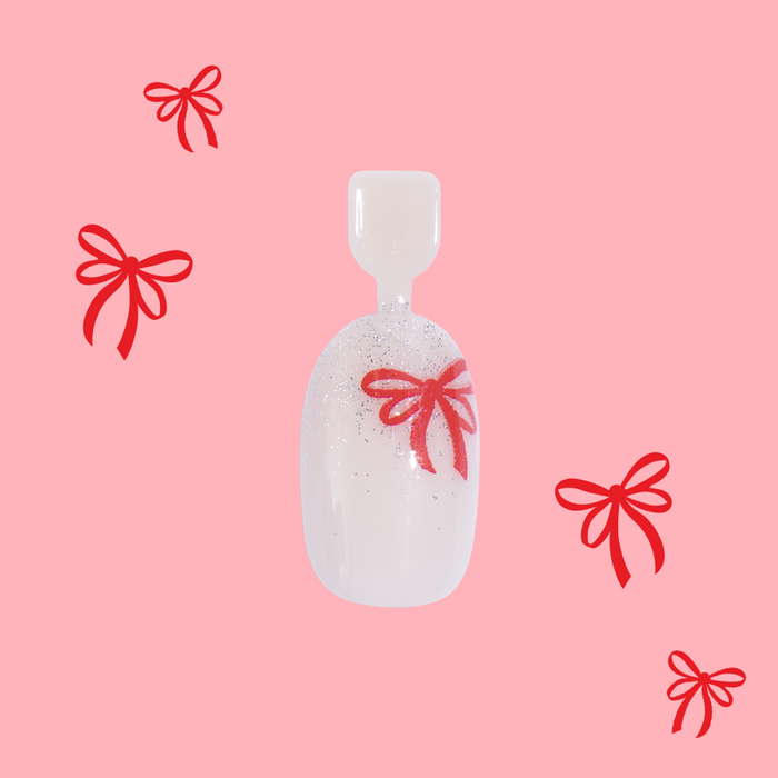 Big Bow Energy - Pressies | Short Medium | Round showing white press-on nail with glittery tips and red bow design on pink background
