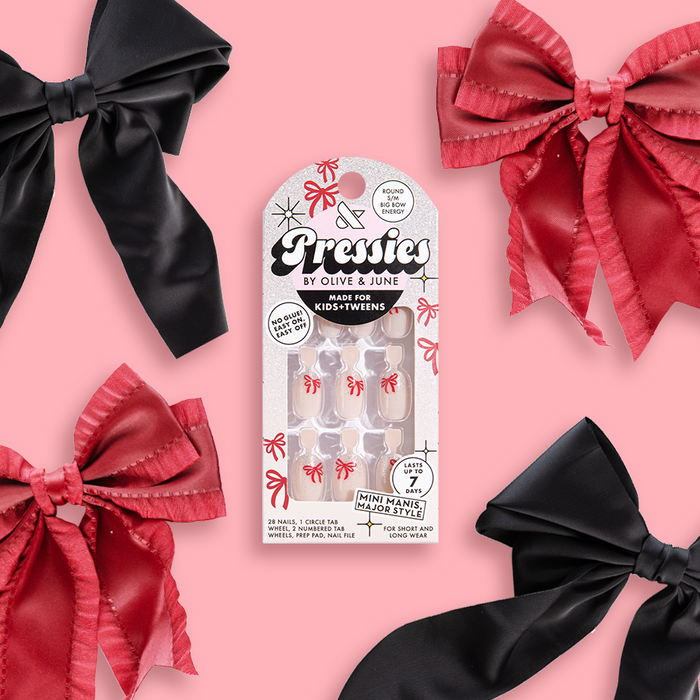 Big Bow Energy - Pressies | Short Medium | Round showing glittery tips with red bow design on clear press-on nails in packaging