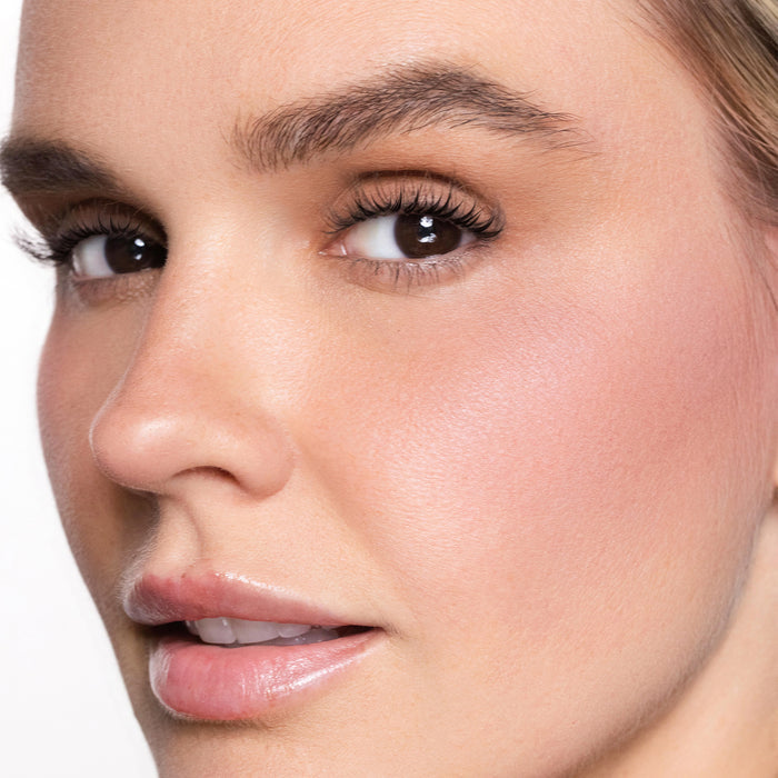 Close-up of a woman's face with color easy going blush