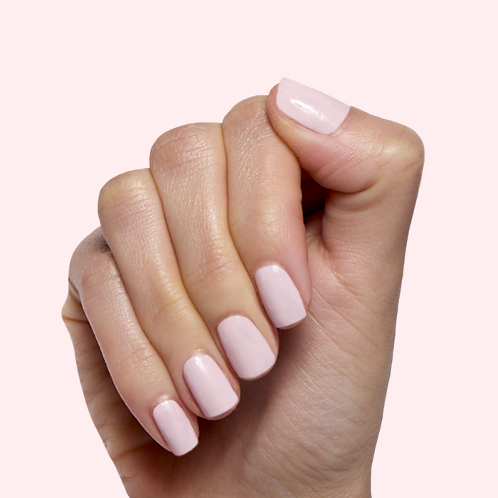 Brave Blush pastel pink nail polish on neatly manicured nails for a smooth, long-lasting at-home mani by Olive and June