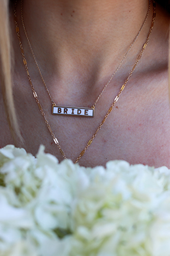 girl wearing bride pendant necklace