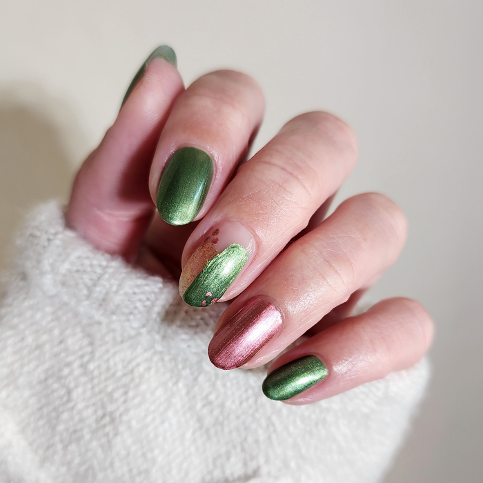 Call Me Jade green and Rosy Quartz pink shimmer mix-and-match manicure with a white sweater