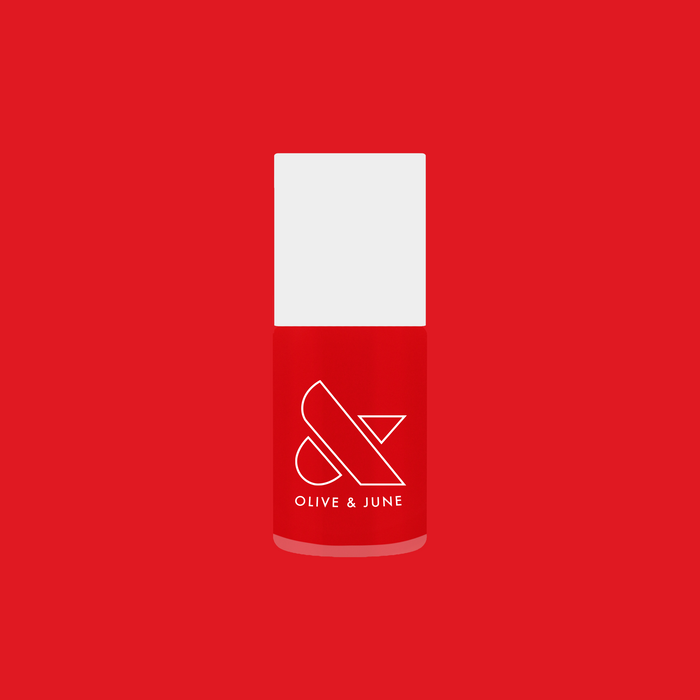 Bottle of Candy Dipped nail polish by Olive and June in bright red jelly for vibrant at-home manicure and pedicure