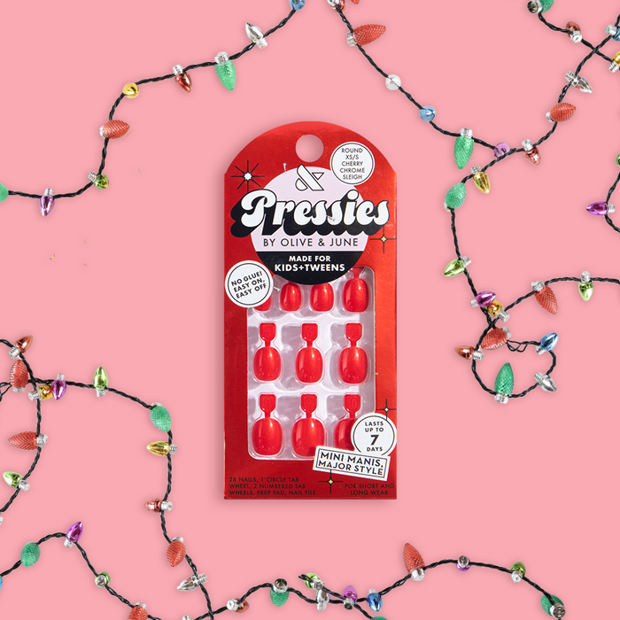 Cherry Chrome Sleigh - Pressies | Extra Short Short | Round showing bright red press-on nails in festive packaging on pink background
