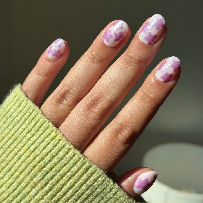 Chrome Petal Party - Press-On | Extra Short | Round neutral pink nails with purple chrome floral design for an easy at-home mani