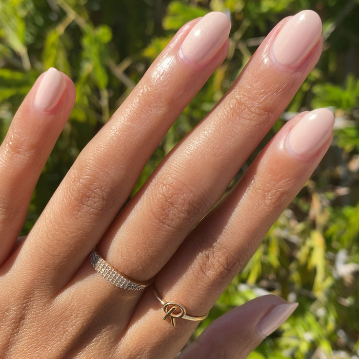hand with smooth nails painted in shimmery neutral beige cold foam pls polish for natural-looking manicure