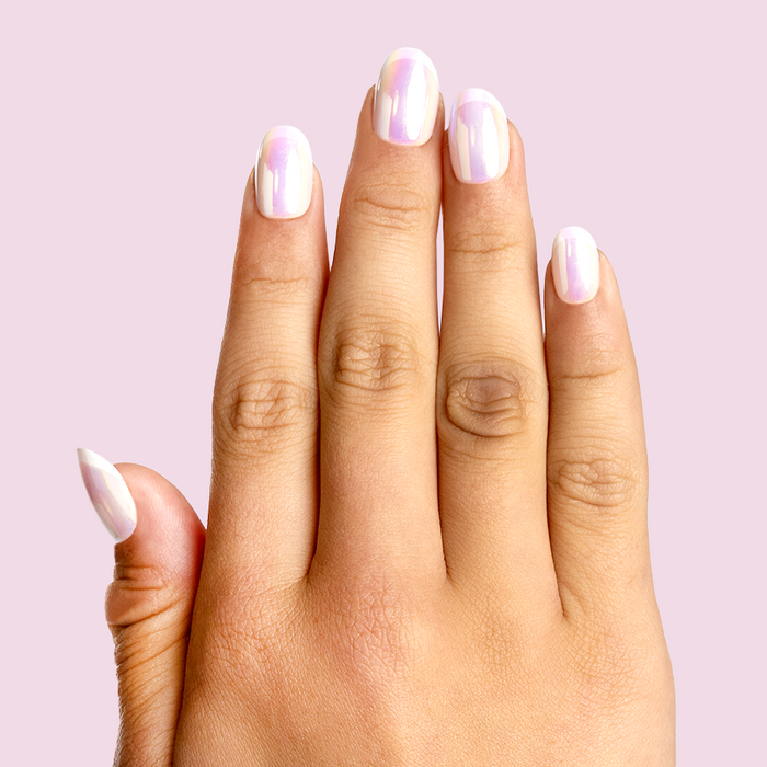 Cool in Chrome French - Pressies | Short Medium | Round showing iridescent chrome shimmer press-on manicure on hand against pale pink background