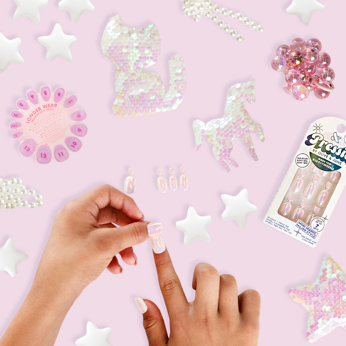 Cool in Chrome French - Pressies | Short Medium | Round showing iridescent chrome shimmer press-on nails on hands with decorative accents