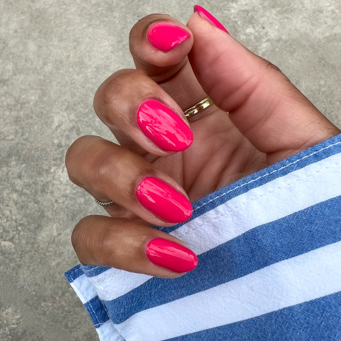Diner Date hot pink gel polish on natural nails with a glossy finish for a vibrant and long-lasting manicure at home