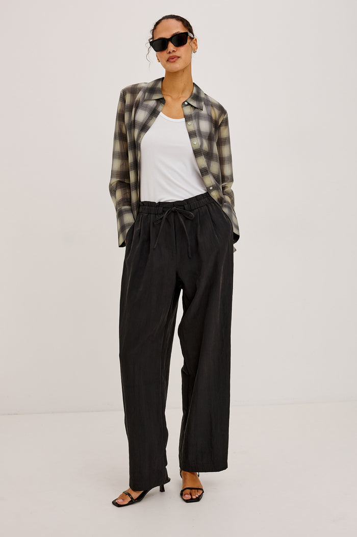Fulham Pant in Nylon With Mid-Rise Wide Leg Fit, Front Pleats, Back Patch Pockets, Back Hem Buttons to Adjust Leg Wide to Slim in Black Colorway - Lower Body Front View Featured on Model