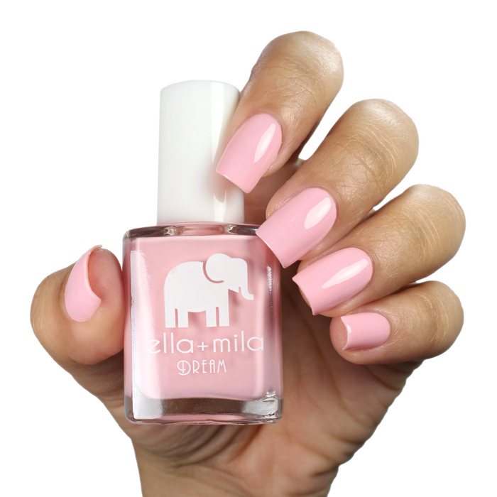 Get to the Pointe warm pink nail polish on a medium skin tone, hand holding the bottle