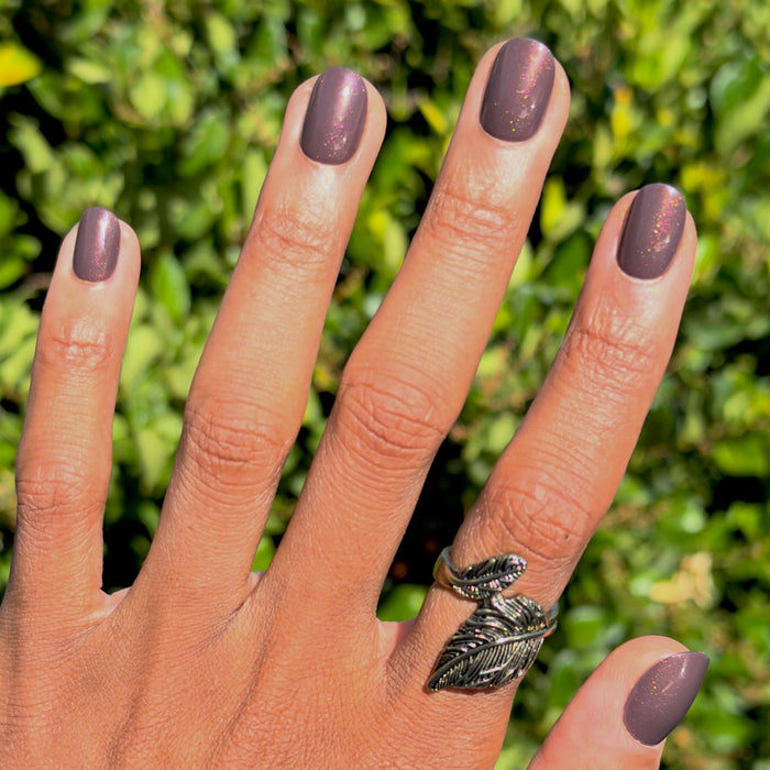 Hand with Goal Getter - Tab Press-On | Extra Short | Round nails in chocolatey neutral with golden brown shimmer outdoors