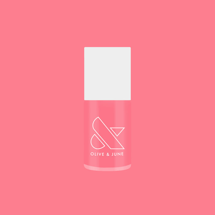 Bottle of Guava Gloss sheer neon pink quick dry nail polish on bright pink background
