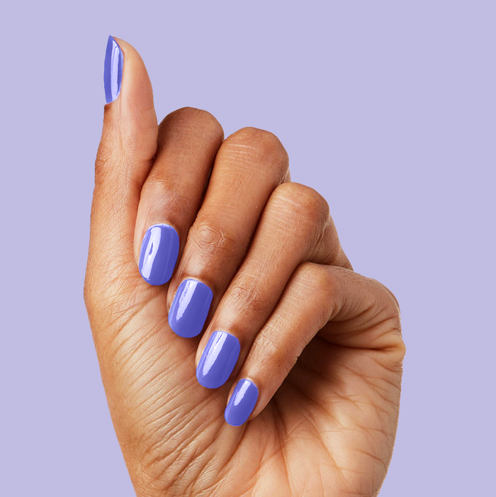 Hand displaying glossy nails painted in House of O&J polish against a soft lavender background for a chic mani