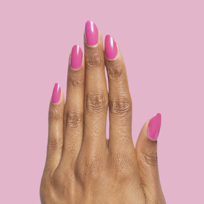 Hand showing shiny nails painted with How Do You Spell Bougainvillea? polish for a bright quick dry mani