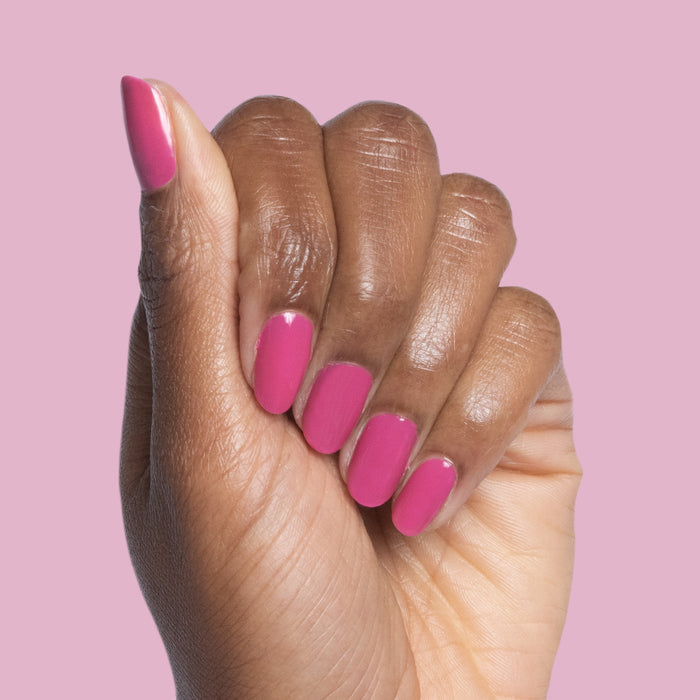Hand displaying nails polished with How Do You Spell Bougainvillea? quick dry polish in hot magenta shade