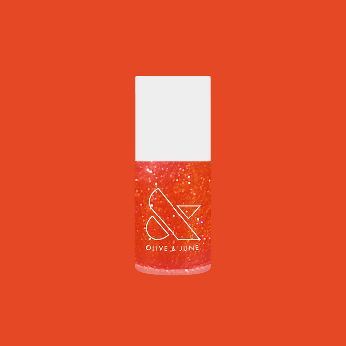 Olive and June bottle of I’ll Take Another Spritz showing sheer red-orange iridescent nail polish with shimmer
