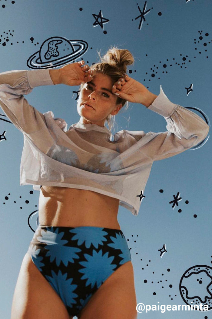 girl in swimsuit posing with planets and stars drawn behind her