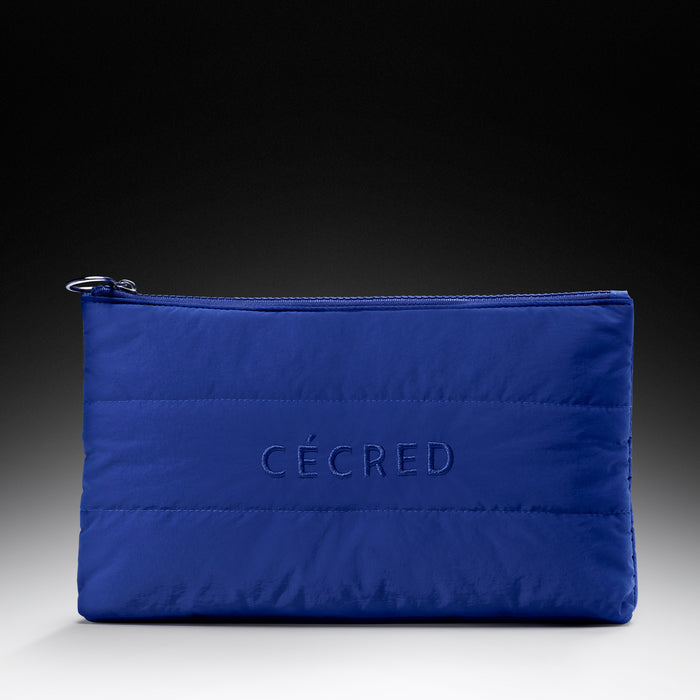 Blue quilted pouch with 'Cécred' branding on a gradient background