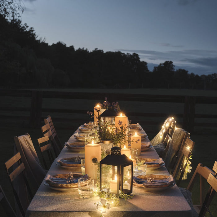 Outdoor dining table with LED candles and lanterns