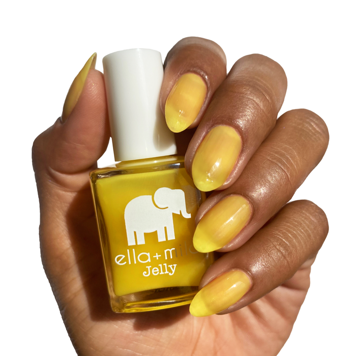 Lemon Drop bright yellow jelly nail polish on a deep skin tone, hand holding the bottle