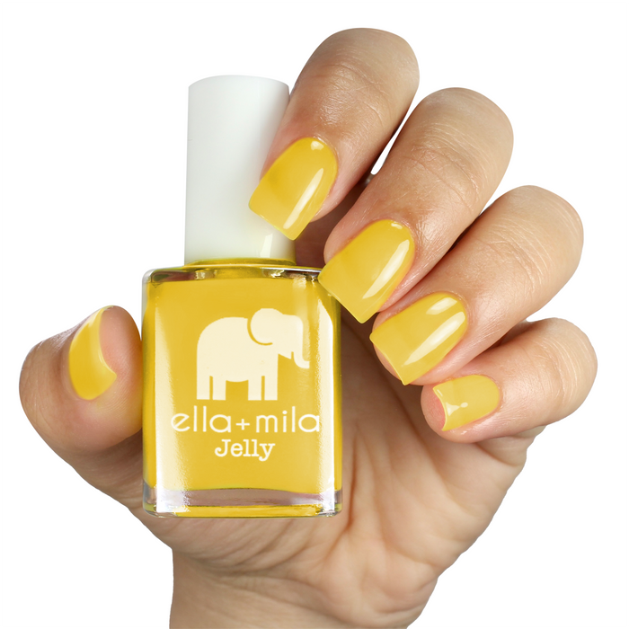 Lemon Drop bright yellow jelly nail polish on a medium skin tone, hand holding the bottle