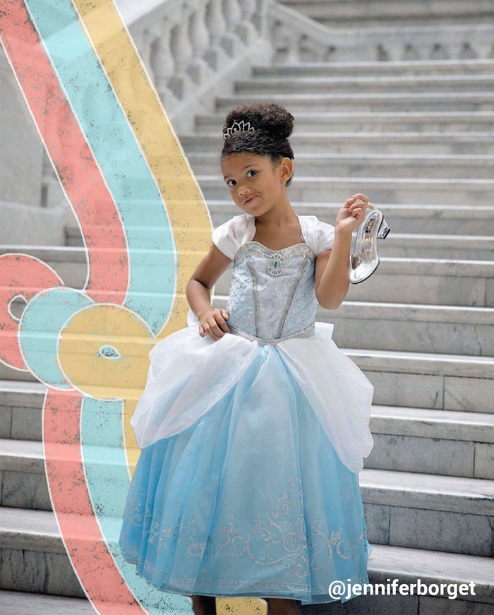 young girl dressed us as a princess with colorful swirls behind her