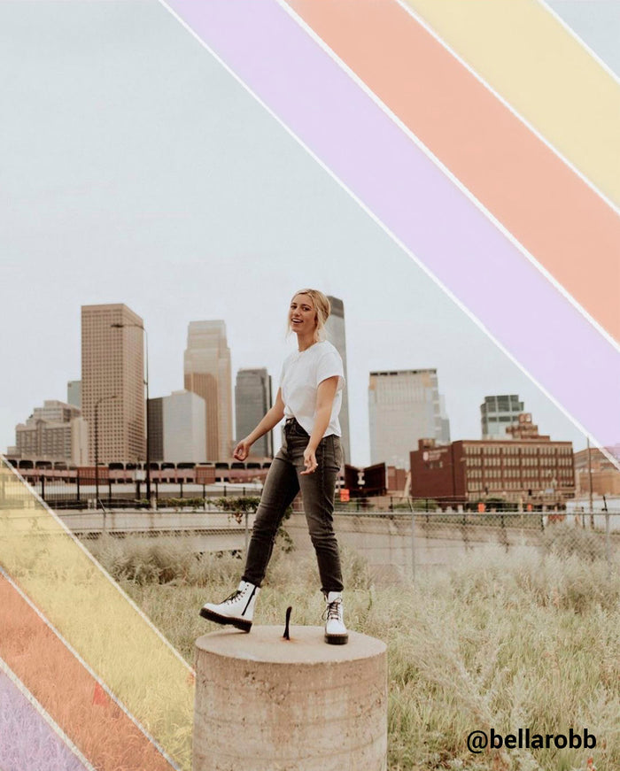girl posing in a city with colorful stripes around her