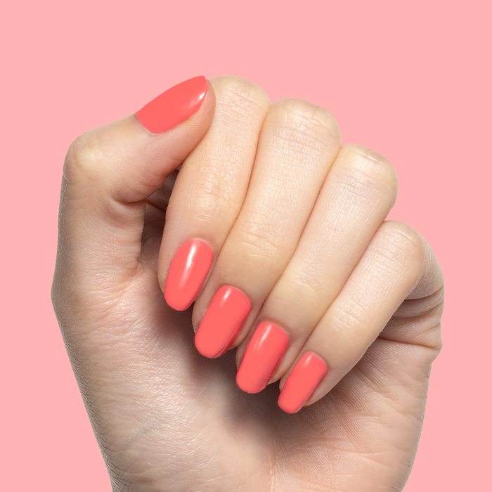Hand showing nails painted with glossy Maine Character Energy gel polish for a bright lobster red manicure