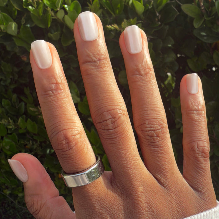 Marshmallow Velvet - Press-On | Extra Short | Squoval soft white velvet effect press-on nails on hand in natural sunlight