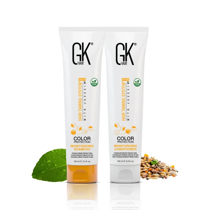 GK Hair Color Protection Moisturizing Shampoo and Conditioner 100 ml tubes side by side with a green leaf and mixed grains