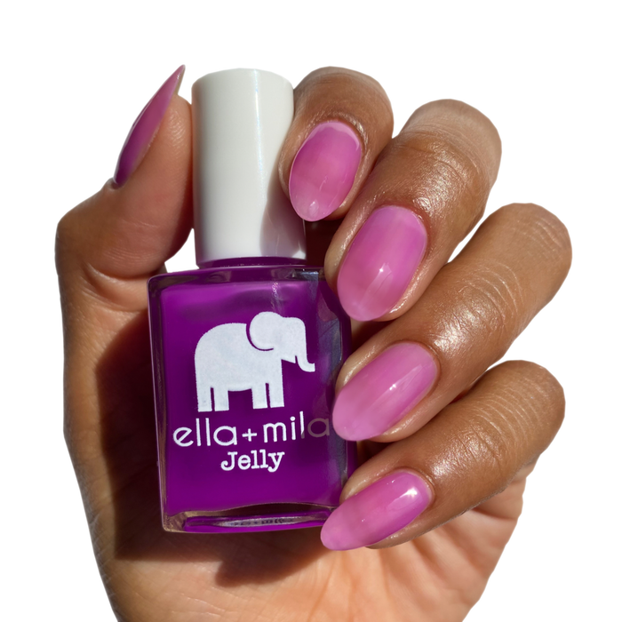 PB Jelly Time bright purple jelly nail polish on a deep skin tone, hand holding the bottle