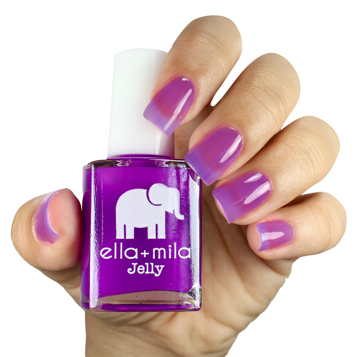 PB Jelly Time purple jelly nail polish on a medium skin tone, hand holding the bottle