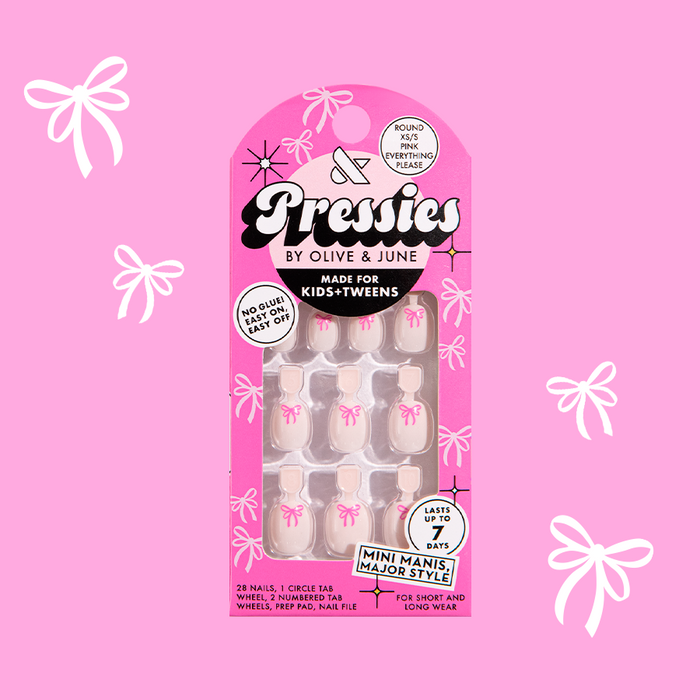 Pink Everything Please - Pressies | Extra Short Short | Round showing baby pink press-on nails with bright pink ribbon design in packaging