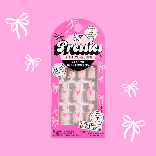 Pink Everything Please - Pressies | Extra Short Short | Round showing baby pink press-on nails with bright pink ribbon design in packaging
